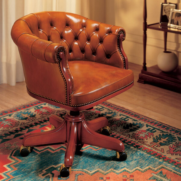 Brown leather presidential armchair with a curved back and buttoned upholstery, mounted on a swivel base with brass casters.