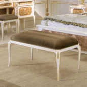 Elegant Italian luxury bench with gold accents in a classic bedroom setting. High-end design furniture.