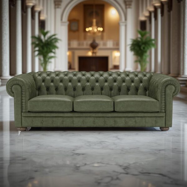 A green leather Chesterfield sofa positioned in a luxurious living room with marble flooring, tall columns, ornamental plants, and an arch leading to a room with chandeliers.