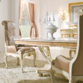 Elegant handmade Italian dining set in wood with ornate chairs, a luxurious table, and a candelabra centerpiece.