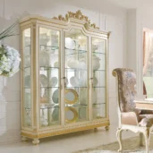 Elegant Italian wooden cabinet with glass doors, showcasing fine china, set in a luxurious villa interior.