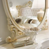 Luxurious bedroom with ornate mirror and decor, showcasing elegant handmade Italian wood furniture and design.