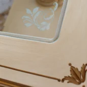 Elegant handmade wooden furniture detail with ornate glass inlay, crafted for luxury villas and palaces in Italy.
