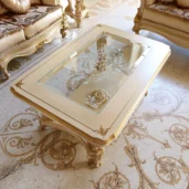 Luxurious handcrafted Italian wooden coffee table with intricate carvings and glass top, perfect for elegant interiors.