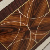 Intricate geometric inlay design in handcrafted wood furniture from Italian luxury interior design collection.