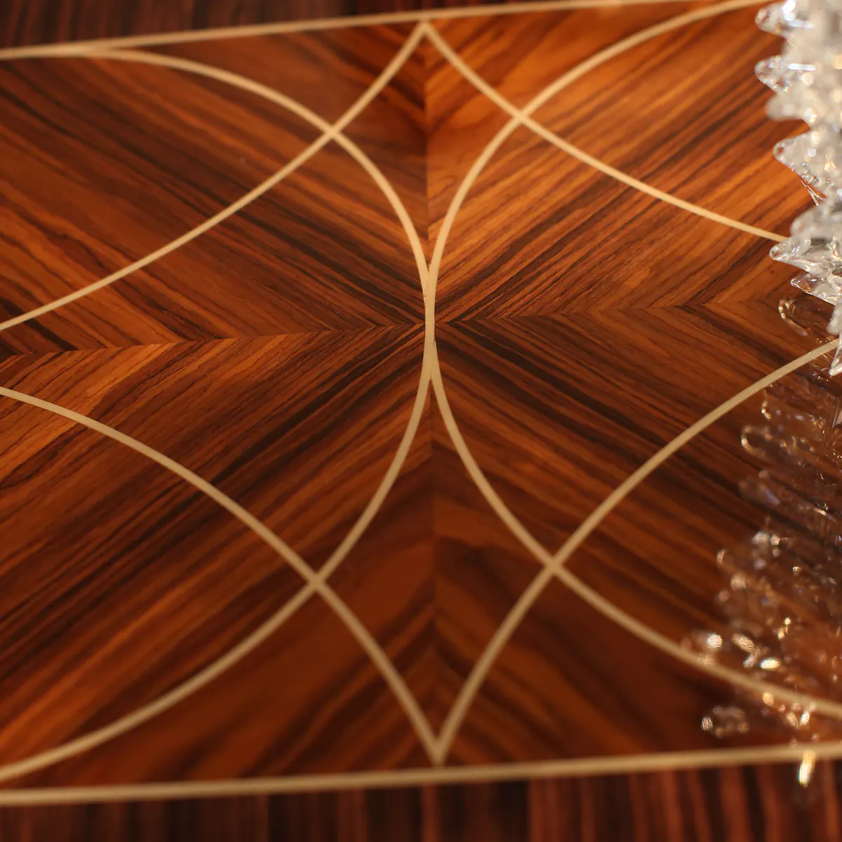 Intricate wooden inlay design on handcrafted furniture by Italian artisans for luxurious interiors.