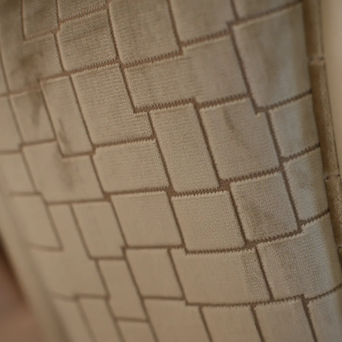 Elegant fabric texture in beige tones with geometric pattern for luxury handmade Italian furniture design.