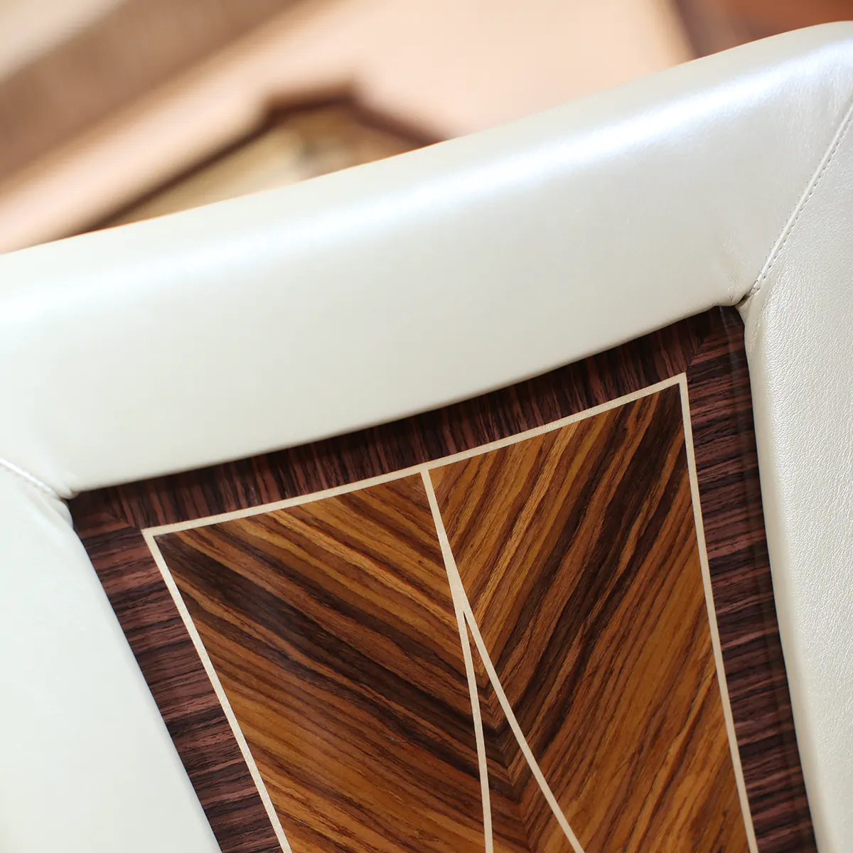 Close-up of handcrafted wooden furniture detail with intricate design, showcasing Italian artisanal quality.