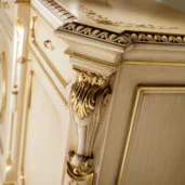 Luxury Italian furniture with intricate gold detailing on an elegant wooden cabinet design. High-end craftsmanship.