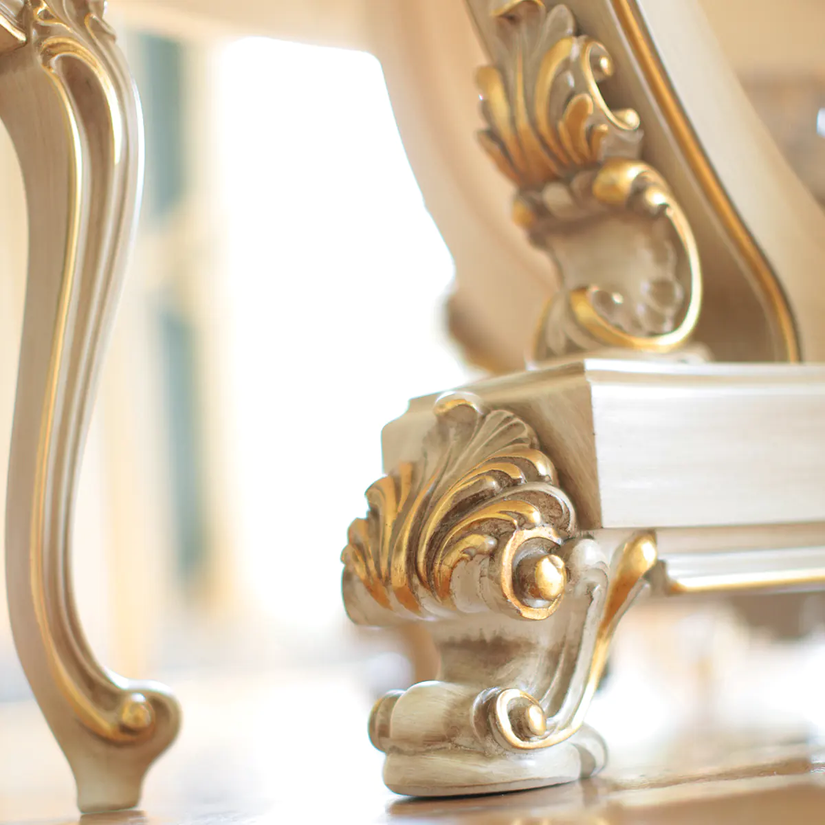 Luxury Italian furniture leg with ornate gold accents, showcasing elegant design and craftsmanship.