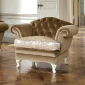 Luxurious Italian velvet armchair with ornate wood legs, elegant design for high-end interior spaces.