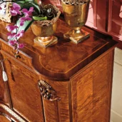 Luxurious handmade wooden cabinet with gold accents and floral decor, crafted for elegant villas and palaces.