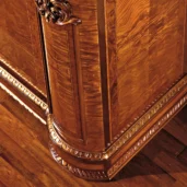 Elegant handcrafted wood furniture with intricate carvings, made in Italy for luxurious villa interiors.