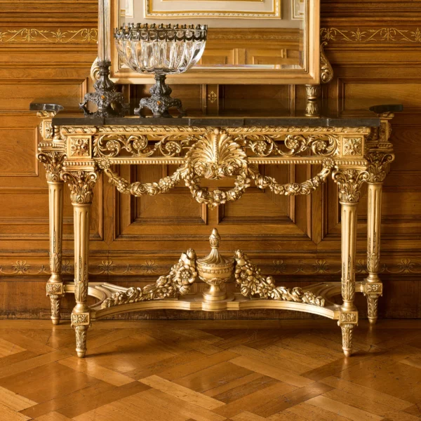 Luxurious handcrafted Italian wooden console table with intricate gold detailing in an elegant villa interior.