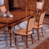 Elegant handmade wood dining set with intricate designs in a luxurious villa interior.