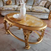 Hand-carved coffee table with intricate details and gold leaf finish