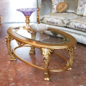 Hand-carved coffee table with intricate details and gold leaf finish