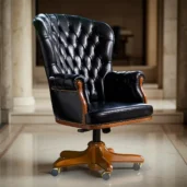 Black leather presidential armchair with a high, wing-shaped back and buttoned upholstery, mounted on a swivel base with brass casters.