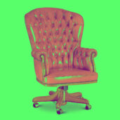 Red leather office chair with tufted backrest and wooden base