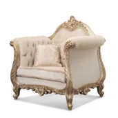 Poltrona Wagner in stile barocco con struttura in legno intagliato dorato, rivestita in tessuto chiaro damascato con lavorazione capitonné.