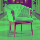 Elegant white leather armchair with tufted back, wooden frame, and nailhead trim