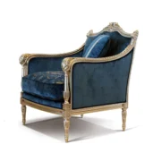 Poltrona di lusso in velluto blu con dettagli dorati, stile classico ed elegante per soggiorno o studio raffinato.