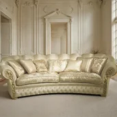 Elegant curved classic-style sofa with decorative fabric, tufted base, and golden accents in a refined living room