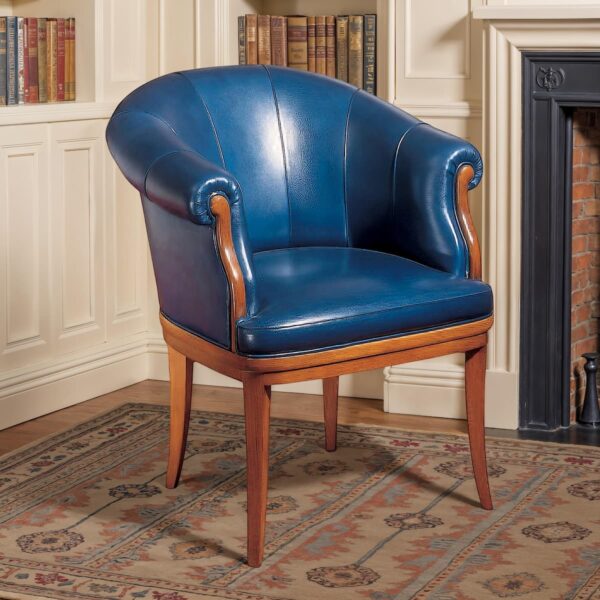Marzorati executive armchair in blue leather, barrel-back design with rolled arms and solid wood legs for classic offices.
