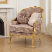 Louis XV style classic armchair featuring a carved wood and gold leaf finish frame, upholstered in beige damask fabric with decorative cushions, on a white background.