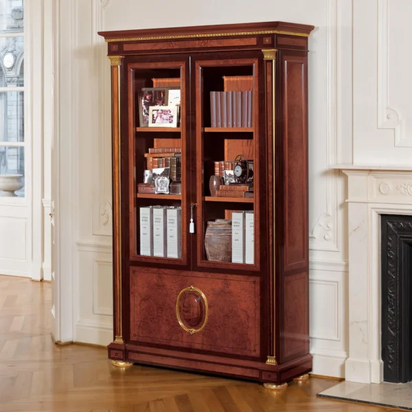 Luxury 2-door walnut bookcase with glass doors, gilded brass details, wooden shelves and an oval medallion lower panel; neoclassical style.