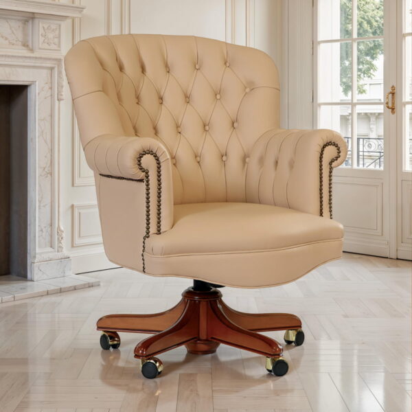 Marzorati executive leather office armchair in beige with tufted back, nailhead-trimmed arms and wooden swivel base on casters.