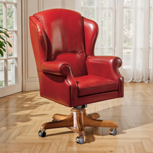 Marzorati executive red leather office armchair with high wingback, rolled arms, loose seat cushion and wooden five-star swivel base on casters.