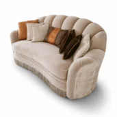 Champagne velvet curved sofa with scalloped shell back, rope piping and bullion fringe, Art Deco-inspired.