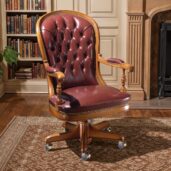 Marzorati executive office chair in burgundy leather with a high button‑tufted back, nailhead trim, padded arm caps on turned supports and a five‑star wooden base on casters.