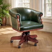 Marzorati executive office chair in dark green leather with an enveloping barrel‑back, rolled arms, wooden trim and a five‑star wooden base on casters, classic luxury style.