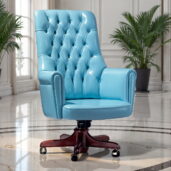 Marzorati executive office chair in light blue leather with a high button‑tufted back, rolled arms and a five‑star wooden base on casters.