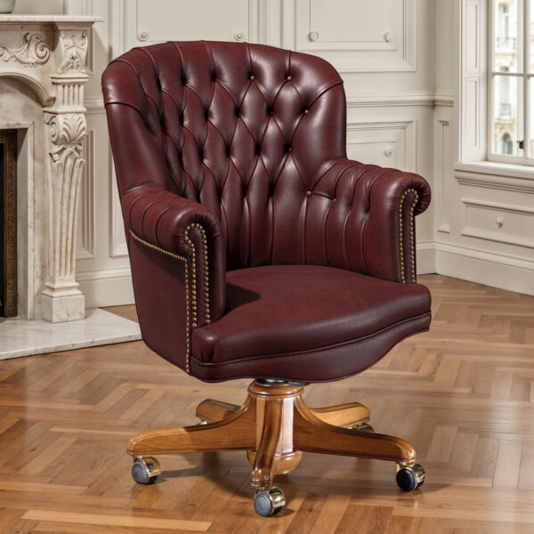 Poltrona in cuoio bordeaux con lavorazione capitonné, ideale per uffici direzionali di lusso e studi professionali classici