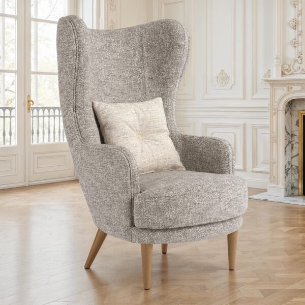 Modern grey fabric armchair with high backrest, wooden legs and decorative cushion