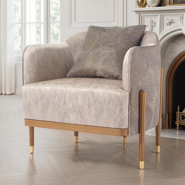 Modern upholstered armchair with elegant fabric, wooden legs with golden finish and matching cushion