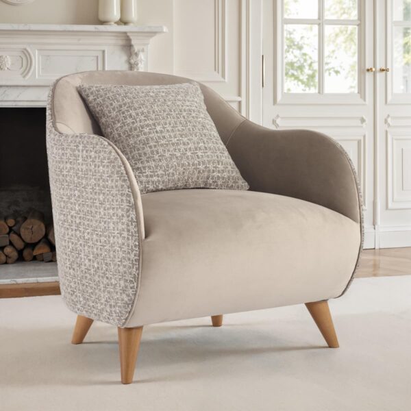 Contemporary armchair upholstered in beige velvet fabric with wooden legs and matching cushion