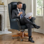 Black leather executive armchair with solid wood base handcrafted by Marzorati