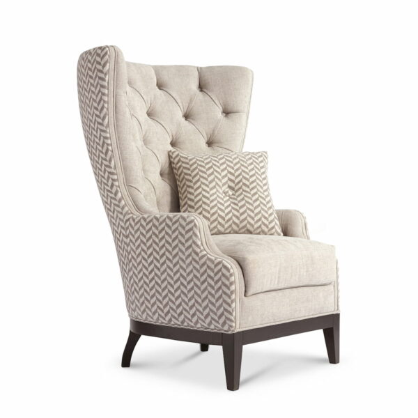 Designer armchair with tufted high backrest, beige fabric upholstery, dark wooden legs and matching cushion