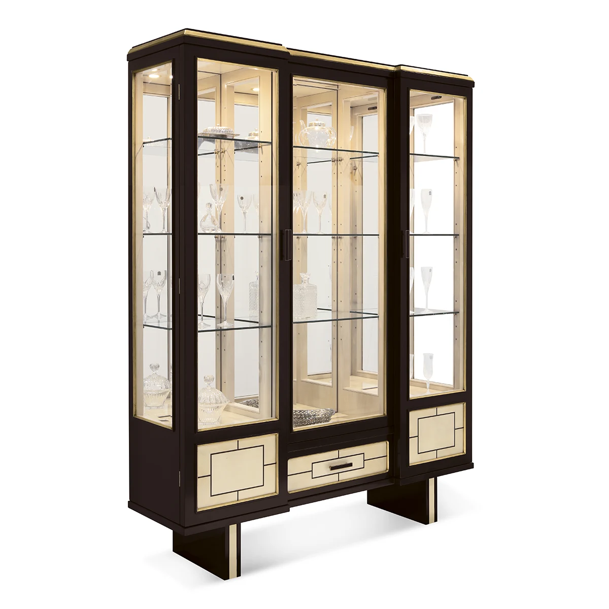 MAYA display cabinet base EN Maya display cabinet with pedestal base, dark wood with gold trim and glass shelves.