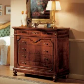 Granducato dresser in hand-carved wood, styled in a luxury bedroom.