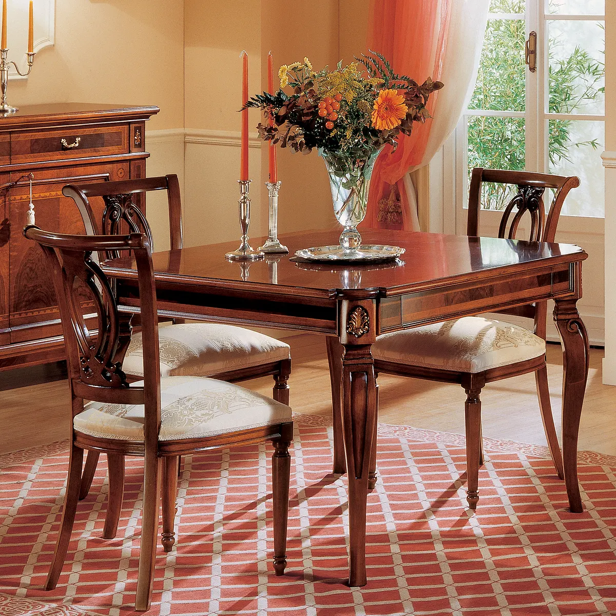 GRANDUCATO dining table EN sedia Granducato table with hand-carved chairs, styled in an Italian villa with floral centerpiece.