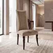 Luxury dining chair with high back, taupe fabric upholstery featuring geometric quilted pattern and ebony wood legs