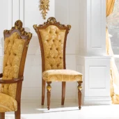 Magnum chair in carved wood with gold upholstery, luxury Italian craftsmanship.