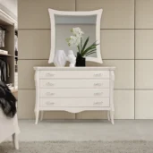 Monte Carlo white chest of drawers with mirror and decorative flowers.