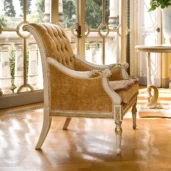Prestige bergère armchair with gold details, elegant setting.