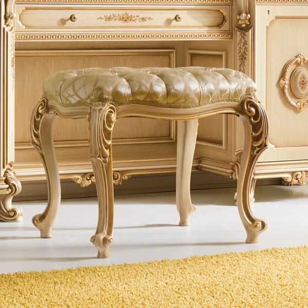 Prestige pouf with tufted seat and carvings.